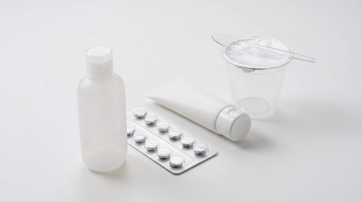 Several semi-flexible packaging examples arranged on a white surface including a squeezable HDPE bottle, a blister pack, a cosmetic tube, and a yogurt cup